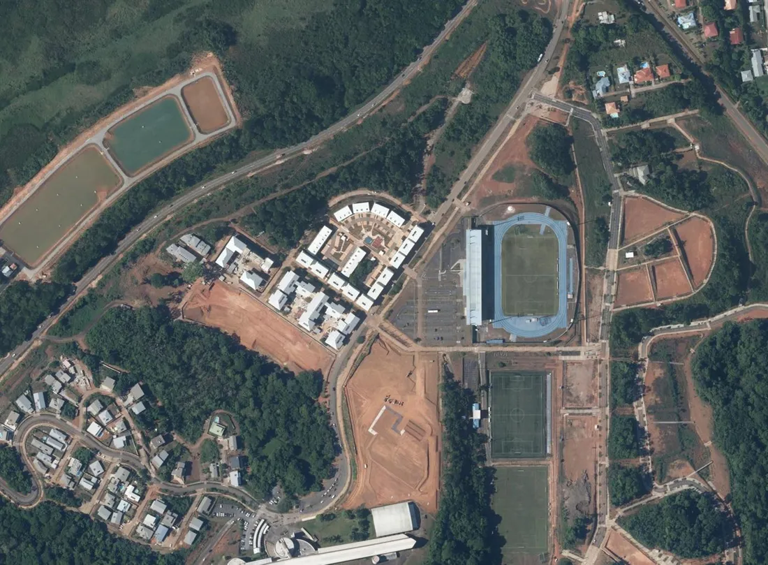 Orthophotographie aérienne de la ZAC écoquartier Georges-Othily à Rémire-Montjoly, en Guyane : premiers îlots de logements collectifs en cours de construction et stade municipal voisin